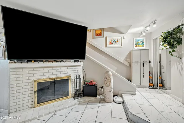 a view of a livingroom with an empty space and a fireplace