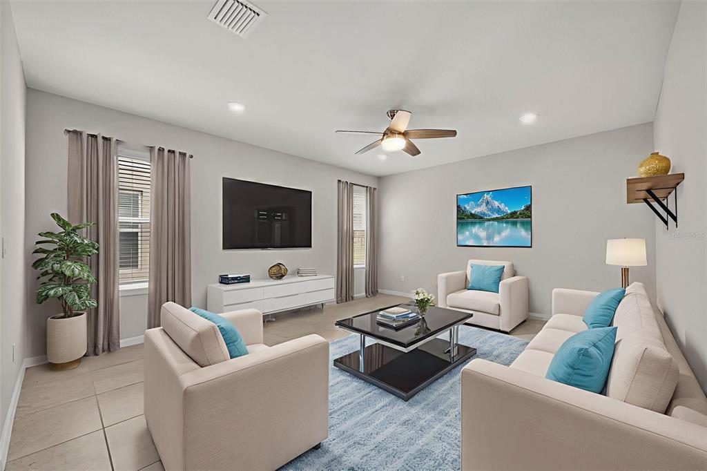 2092 Cross Prairie Parkway Kissimmee, FL 34744 - Photo 20 of 40 a living room with furniture and a flat screen tv