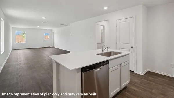 a kitchen with stainless steel appliances a sink and a refrigerator