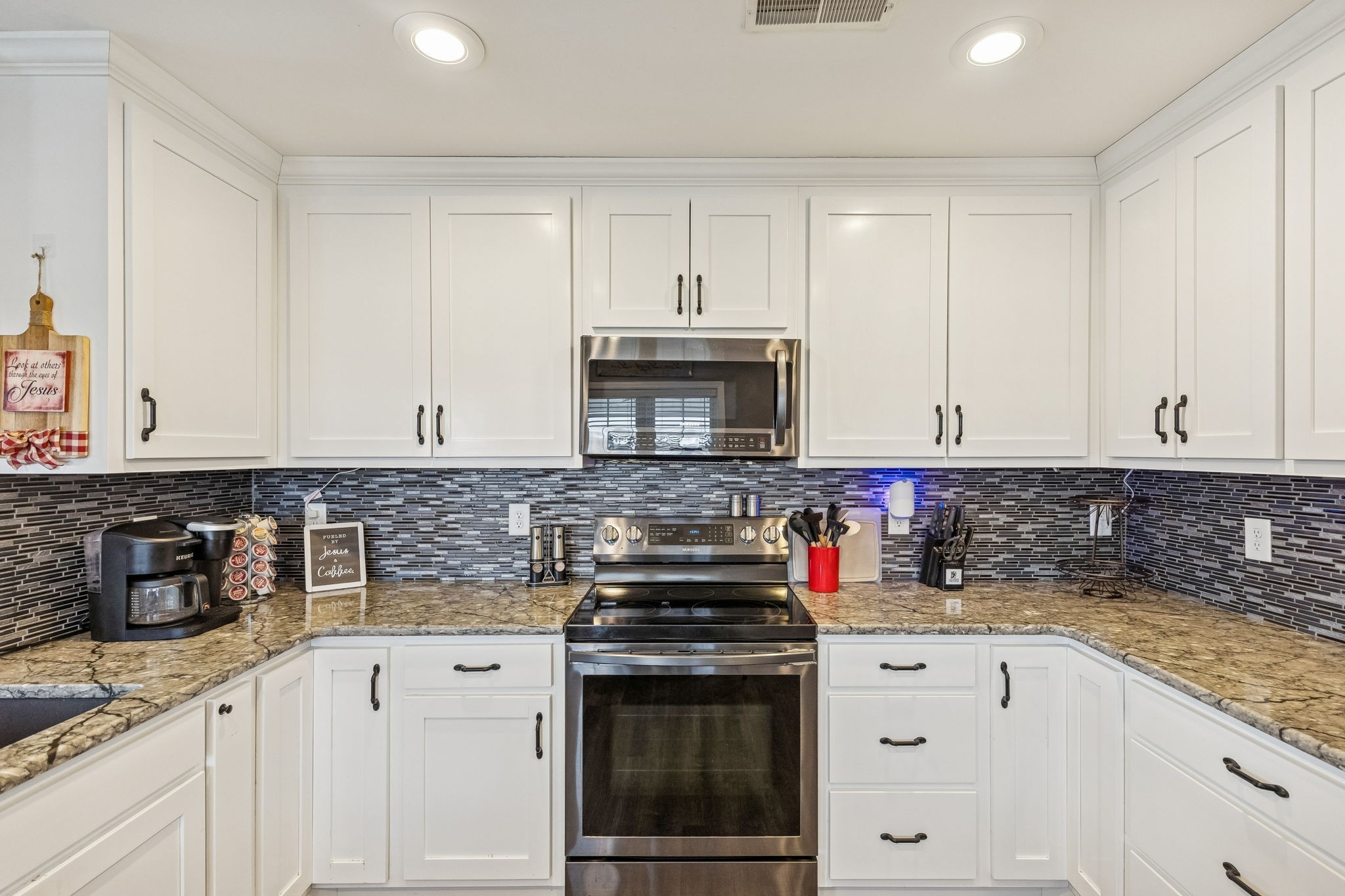 403 Bland Road Estill Springs, TN 37330 - Photo 12 of 66 a kitchen with stainless steel appliances granite countertop a stove a sink and a white cabinets