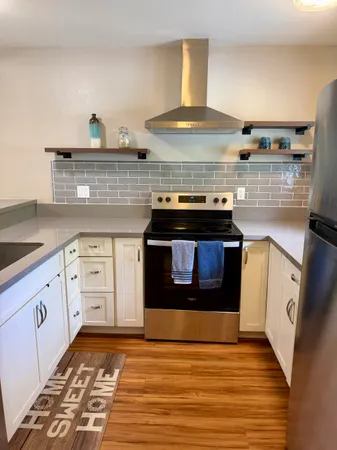a kitchen with a sink stove and cabinets