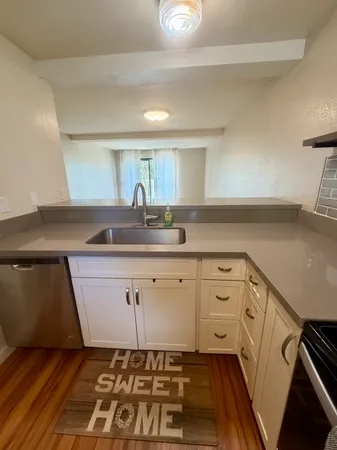 a bedroom with a bed and a flat tv screen next to a window