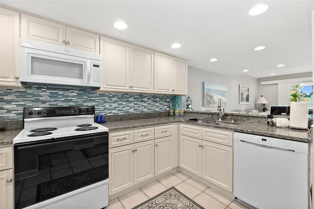 a kitchen with cabinets stainless steel appliances and a sink