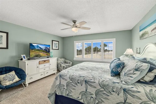 a bedroom with furniture and a flat screen tv
