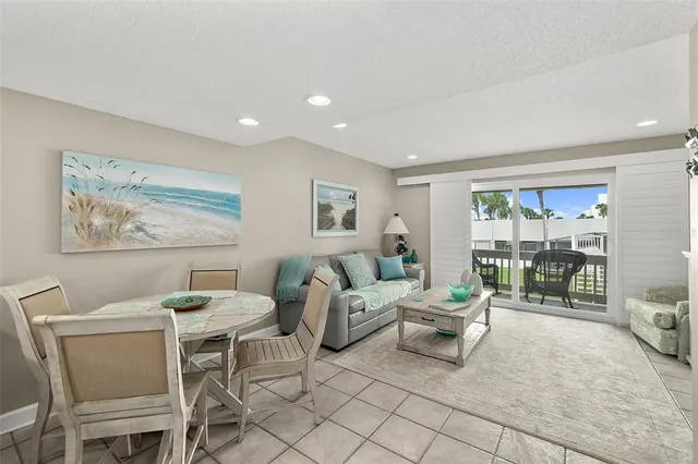 a living room with furniture a lamp and a large window