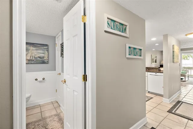a view of a hallway with wooden floor and a living room