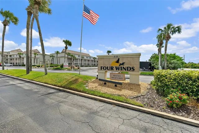 a view of a house with a yard and potted plants