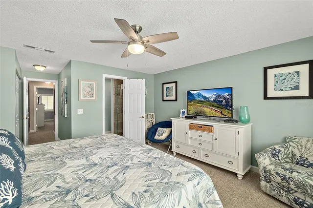 a bedroom with furniture and a mirror