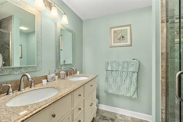 a bathroom with double vanity sink and a mirror