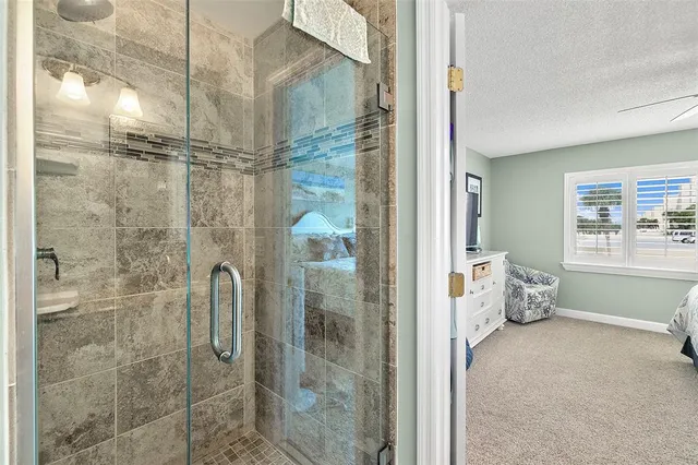 a bathroom with a granite countertop shower