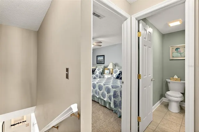 a bathroom with a granite countertop sink a toilet and a mirror
