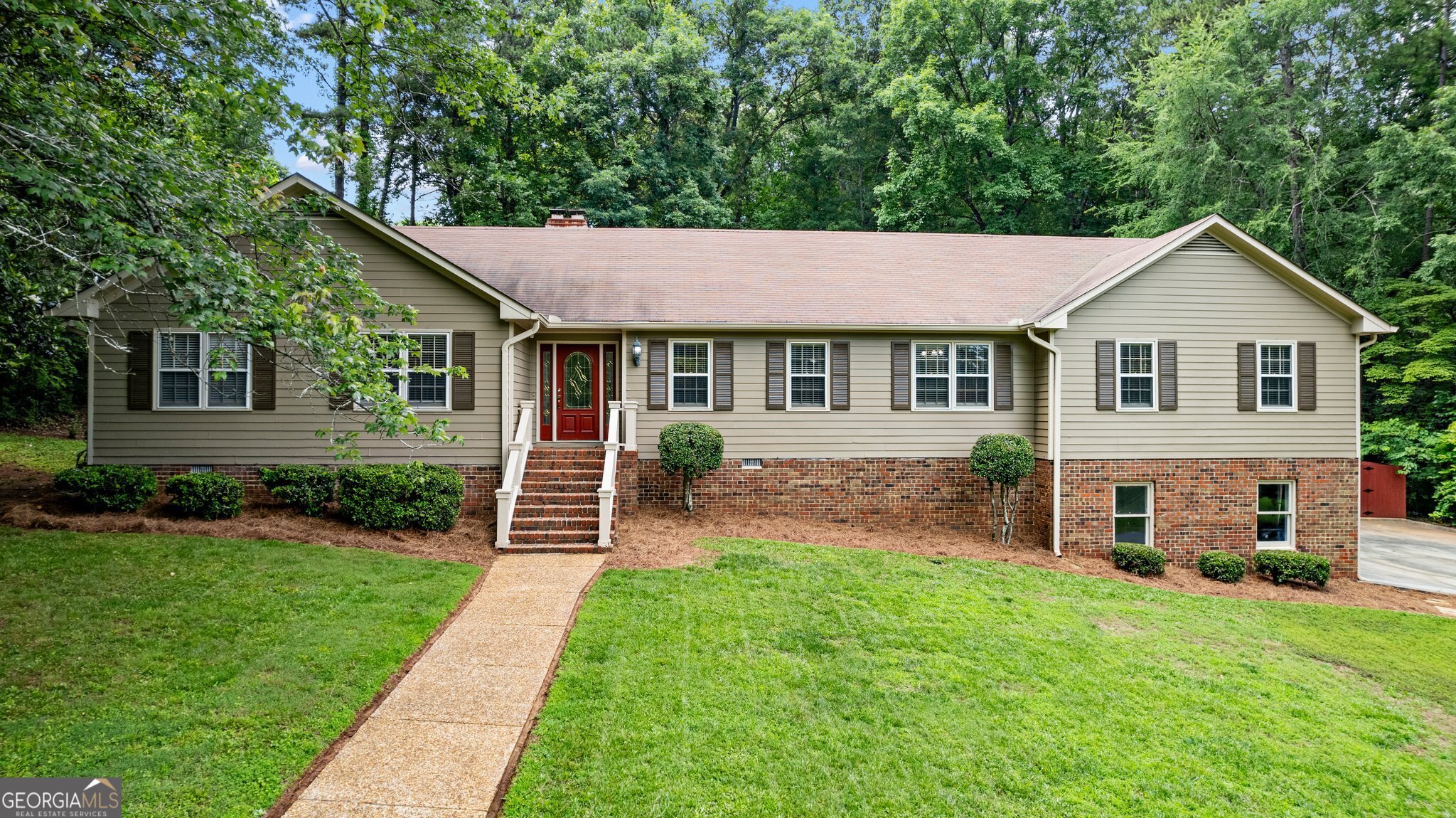 207 Saddle Mountain Road Southeast Rome, GA 30161 - Photo 1 of 1 a front view of a house with a yard and green space