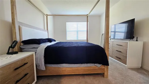 a bedroom with a bed and a flat screen tv