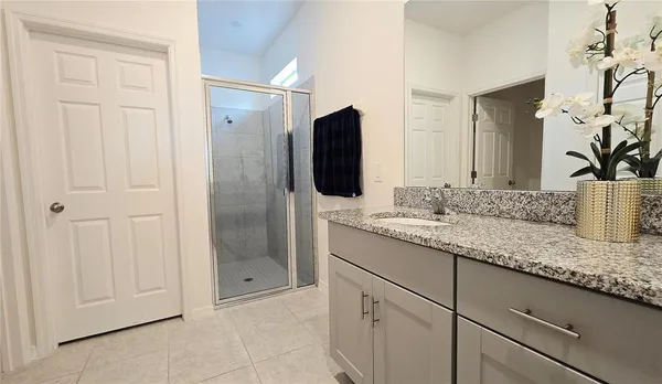 a bathroom with a granite countertop sink and a mirror