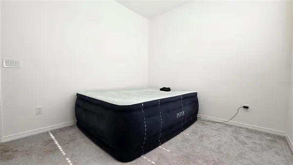 a bathroom with a granite countertop sink and a toilet