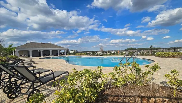 a view of a patio with table and chairs potted plants