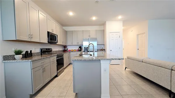 a kitchen with stainless steel appliances granite countertop a refrigerator sink and cabinets