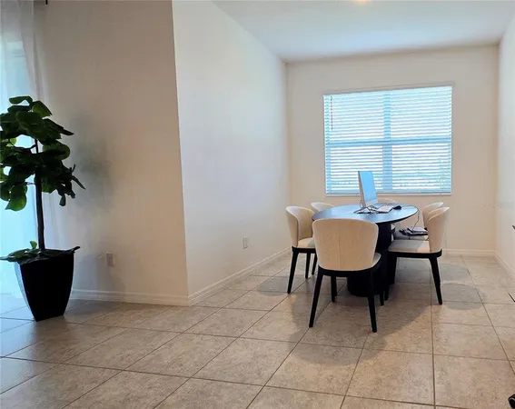 a view of a dining room with furniture and window