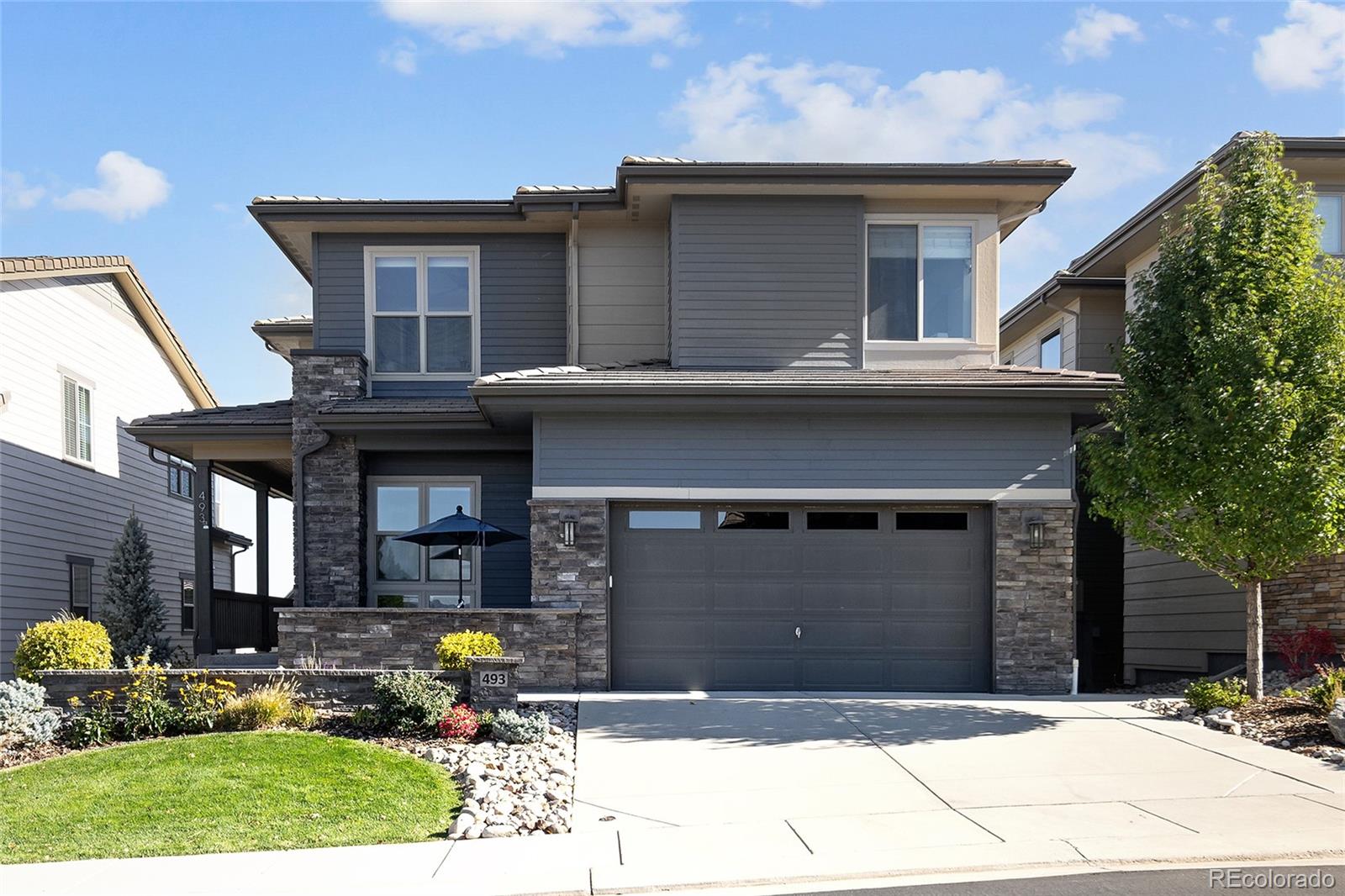 493 Meadowleaf Lane Highlands Ranch, CO 80126 - Photo 1 of 48 a front view of a house with a garden
