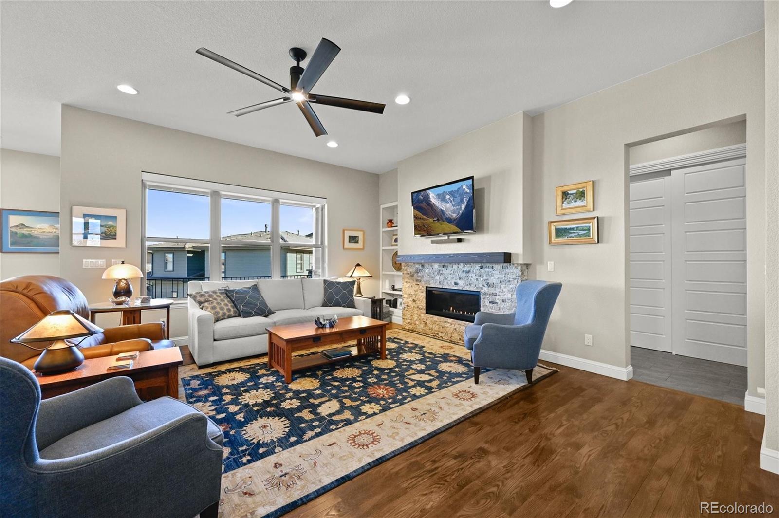 493 Meadowleaf Lane Highlands Ranch, CO 80126 - Photo 14 of 48 a living room with furniture a fireplace and a window