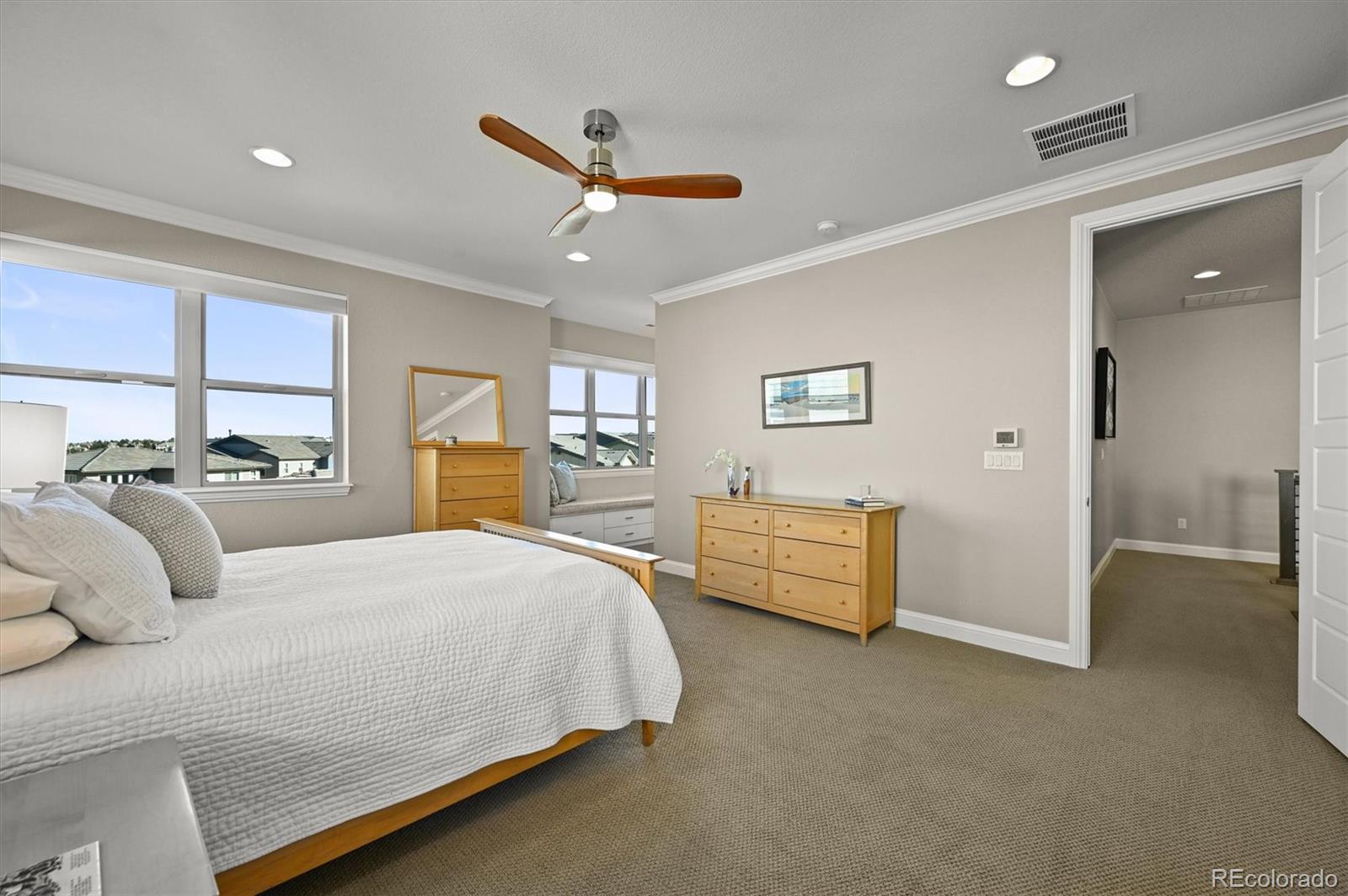 493 Meadowleaf Lane Highlands Ranch, CO 80126 - Photo 19 of 48 a bedroom with a bed and ceiling fan