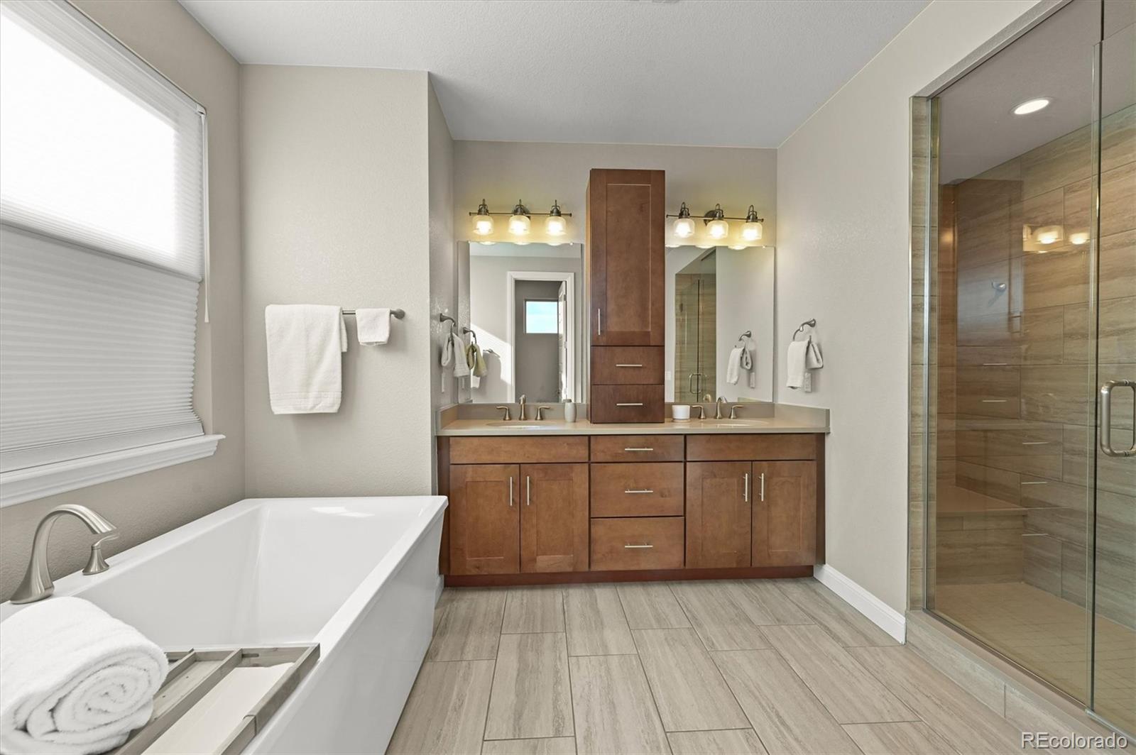 493 Meadowleaf Lane Highlands Ranch, CO 80126 - Photo 23 of 48 a bathroom with a granite countertop sink mirror and bathtub