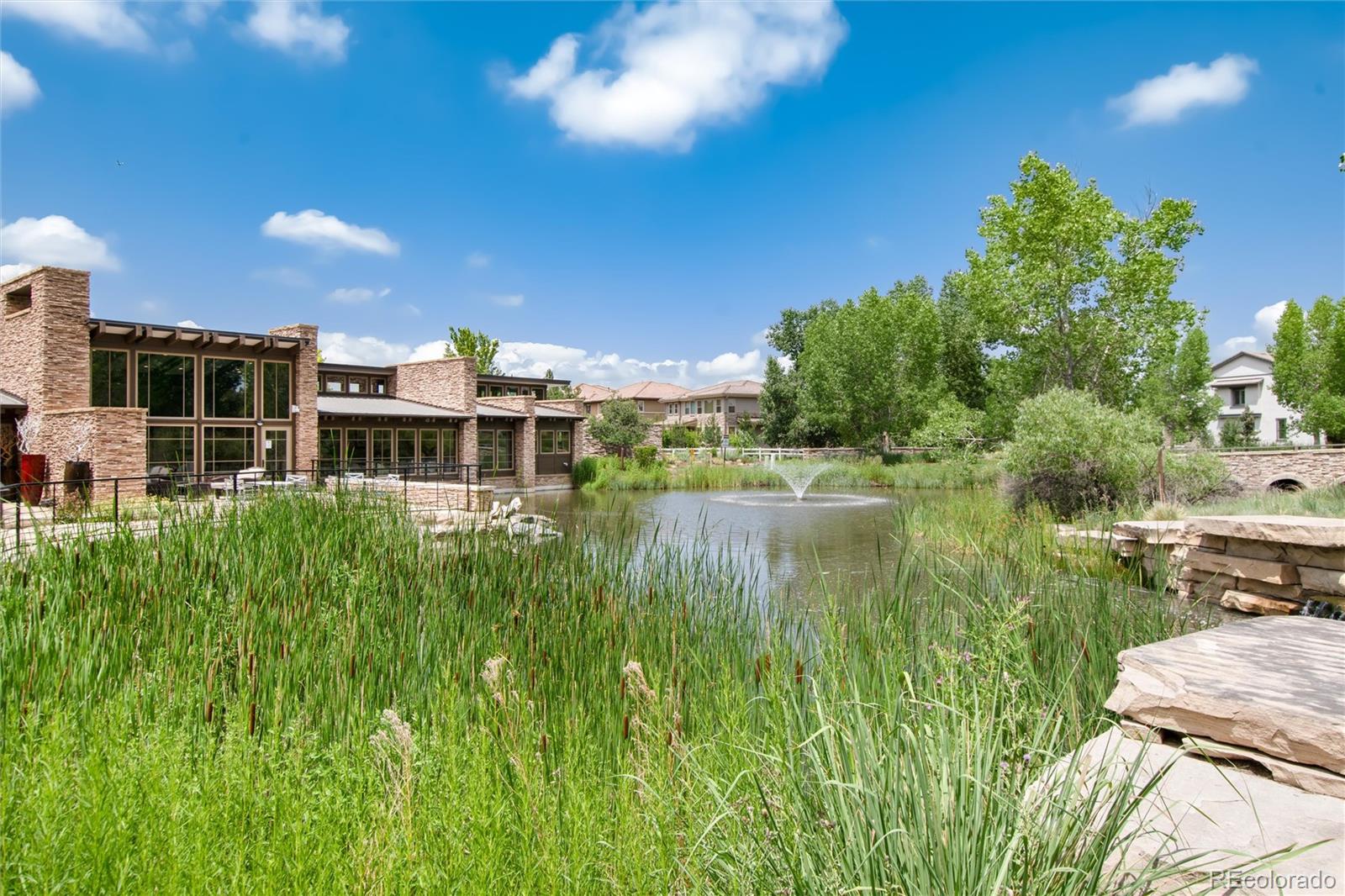 493 Meadowleaf Lane Highlands Ranch, CO 80126 - Photo 47 of 48 a view of a lake with a building in the background