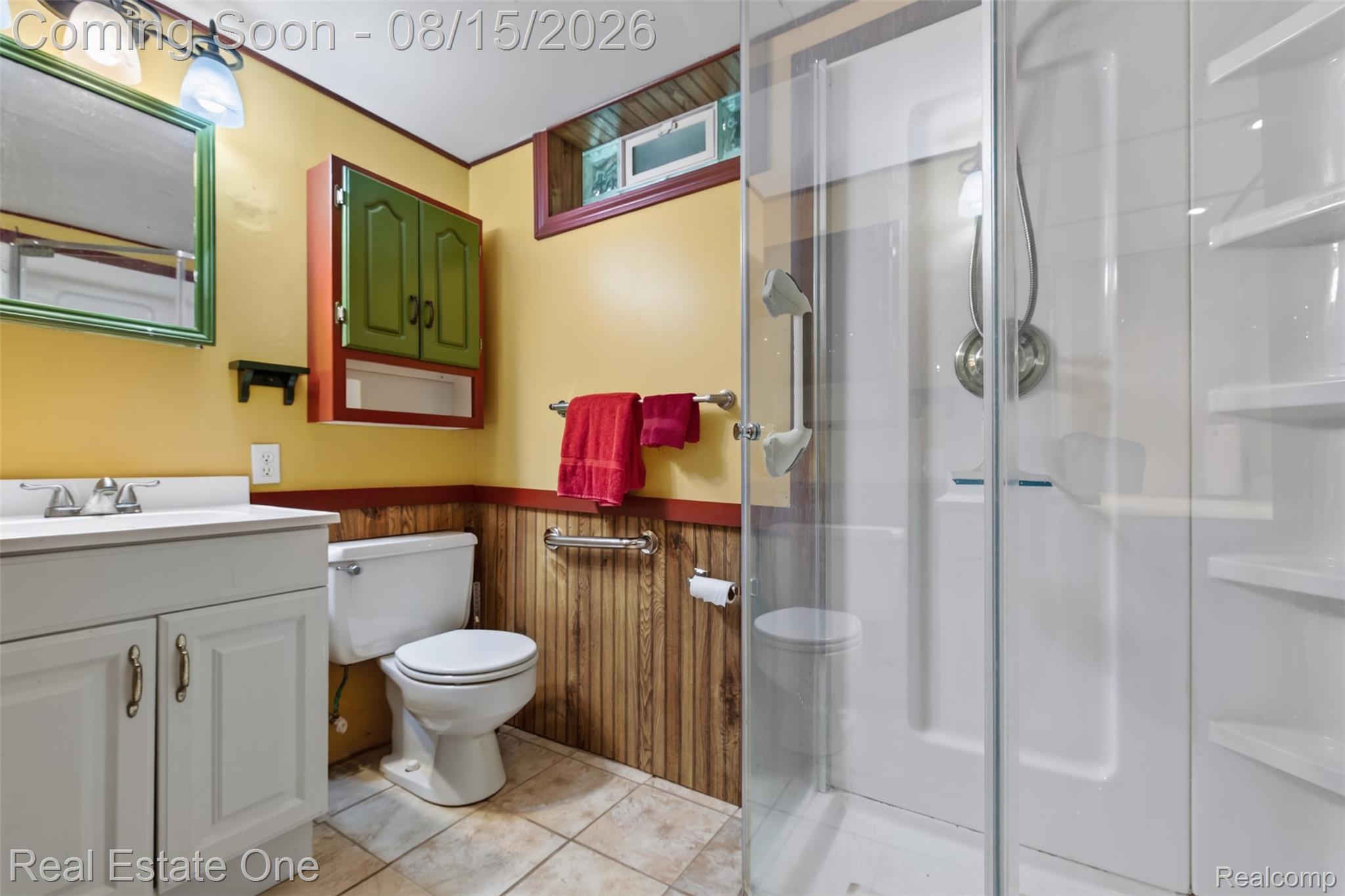 454 South Baldwin Road Oxford, MI 48371 - Photo 30 of 64 Lower Level bath has Shower stall and features white vanity and tile flooring, enclosed shower.