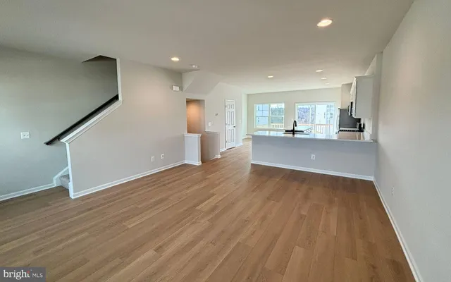 a view of a kitchen with wooden floor and electronic appliances
