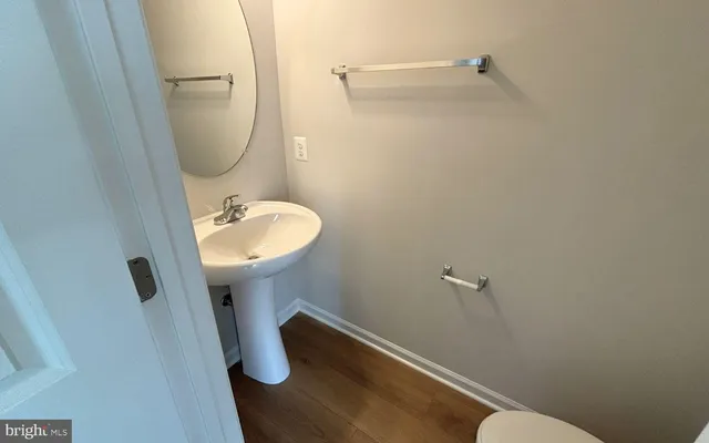 a bathroom with a sink toilet and a mirror