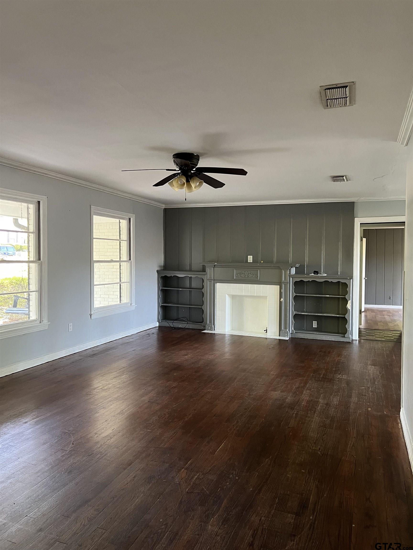 1223 South Azalea Drive Tyler, TX 75701 - Photo 4 of 11 a view of empty room with wooden floor and window