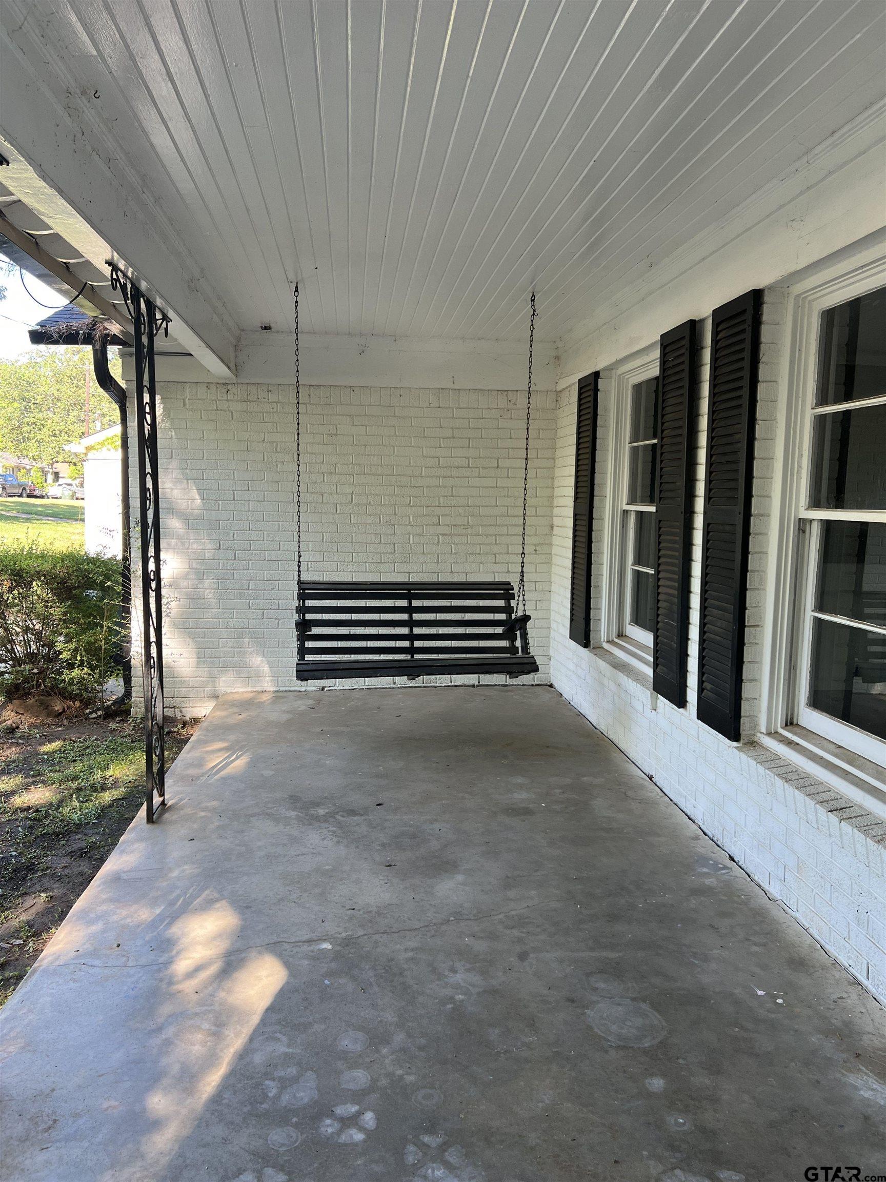 1223 South Azalea Drive Tyler, TX 75701 - Photo 8 of 11 a view of a porch with wooden floor and stairs