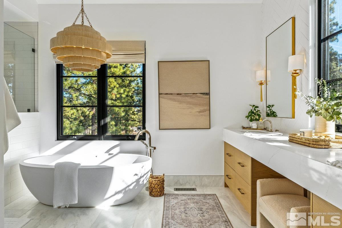 182 Tor Court Carson City, NV 89705 - Photo 15 of 40 a spacious bedroom with a bed and a table