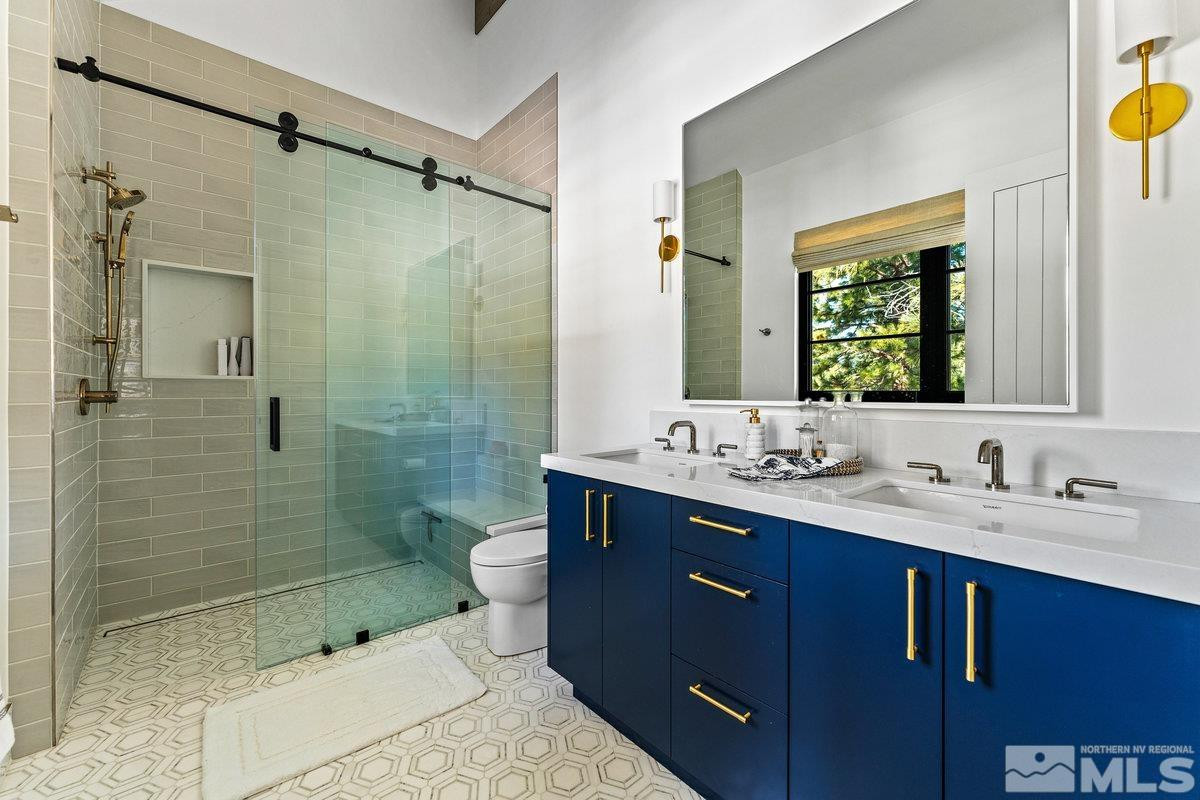 182 Tor Court Carson City, NV 89705 - Photo 23 of 40 a bathroom with a sink and mirror with shower