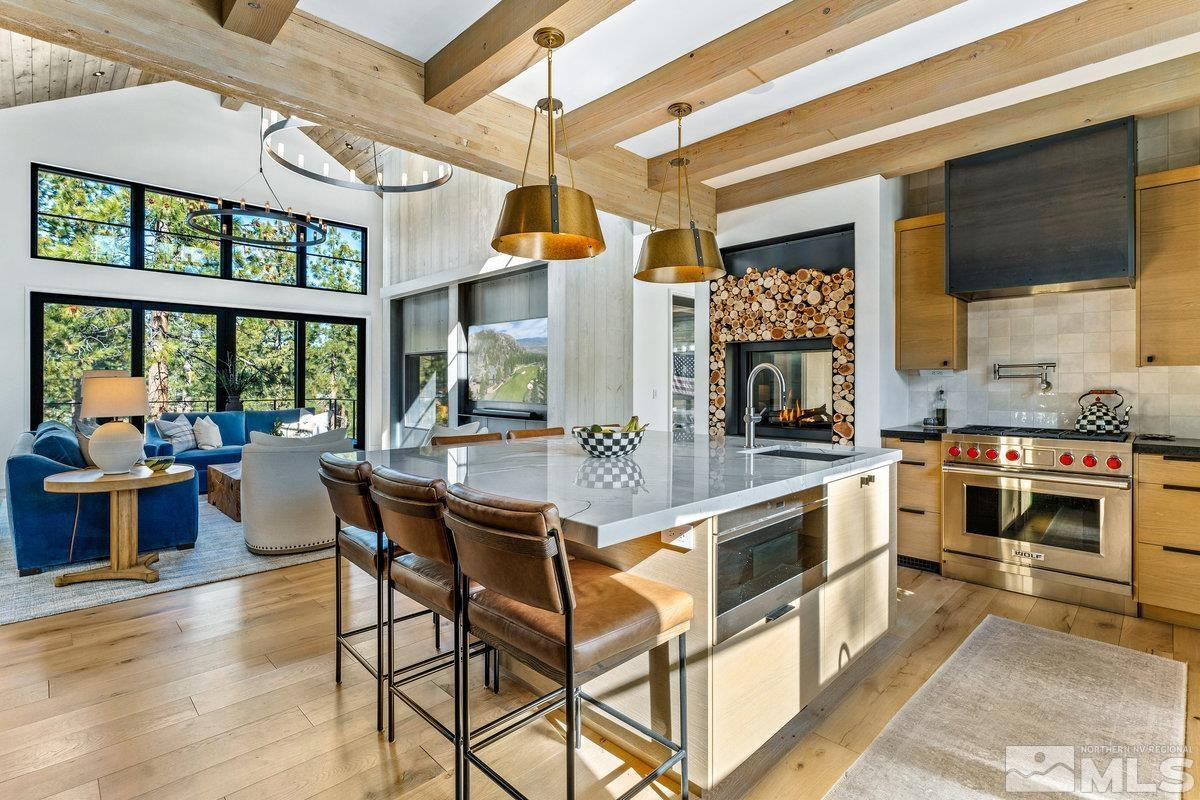 182 Tor Court Carson City, NV 89705 - Photo 8 of 40 a kitchen with a stove a counter space a sink and dining table with wooden floor