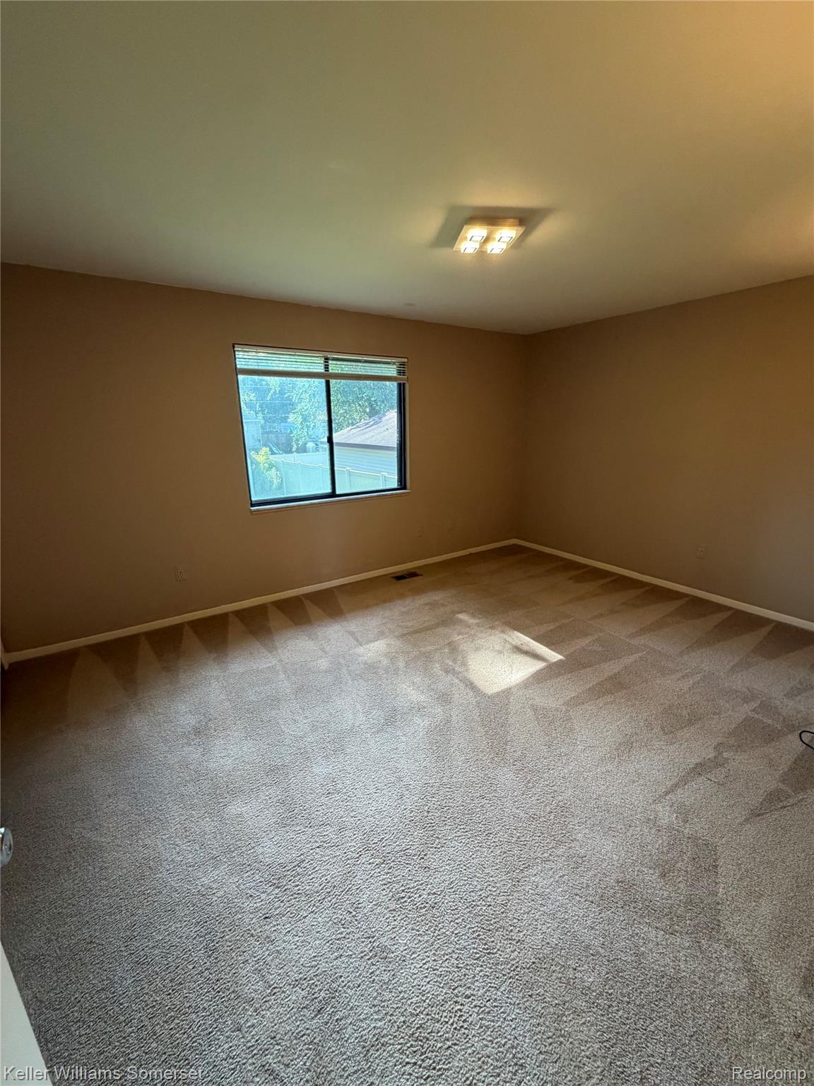 3277 Eastern Avenue Rochester, MI 48307 - Photo 6 of 13 Carpeted room with a rectangular window and a flush-mount ceiling light fixture
