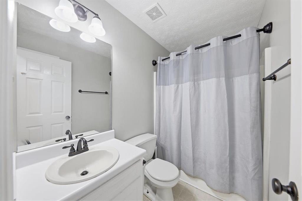 493 Youth Jersey Road Covington, GA 30014 - Photo 22 of 52 a bathroom with a sink toilet and shower