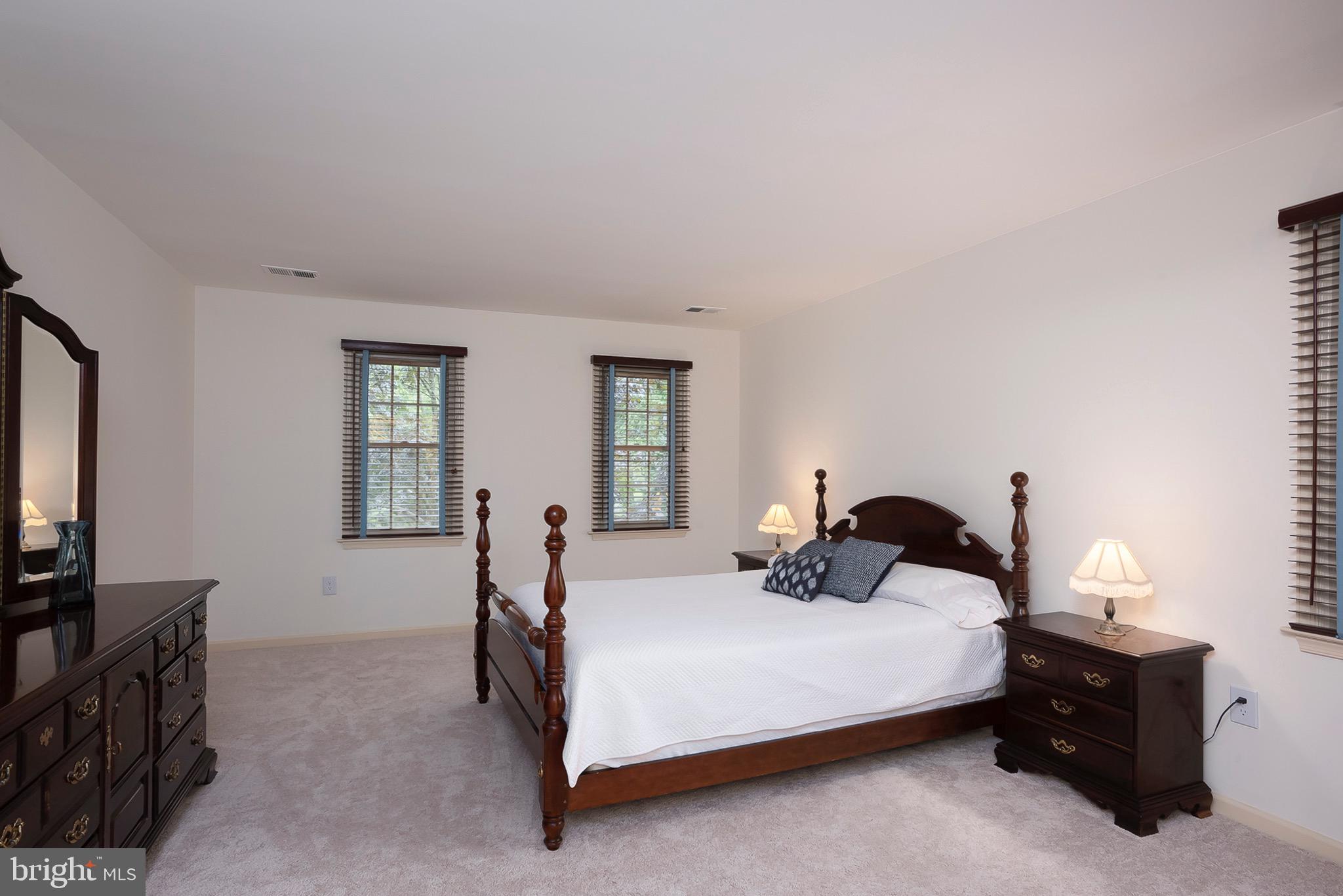 5208 Durham Road East Columbia, MD 21044 - Photo 22 of 36 a bedroom with a bed and a flat tv screen on the dresser