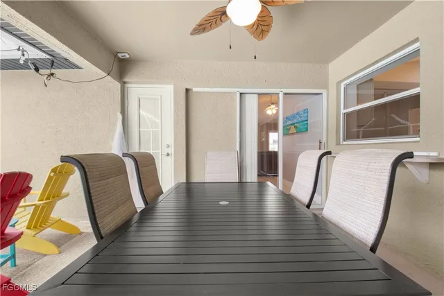 a view of a living room with hardwood floor and a ceiling fan