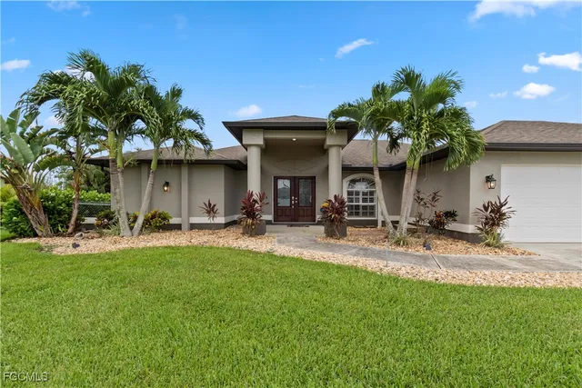 a view of a house with backyard and sitting area