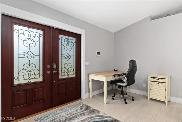 a view of a workspace with furniture and a window
