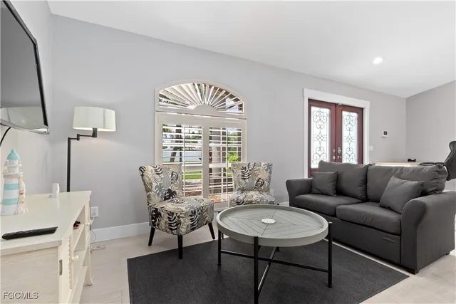 a living room with furniture and a chandelier