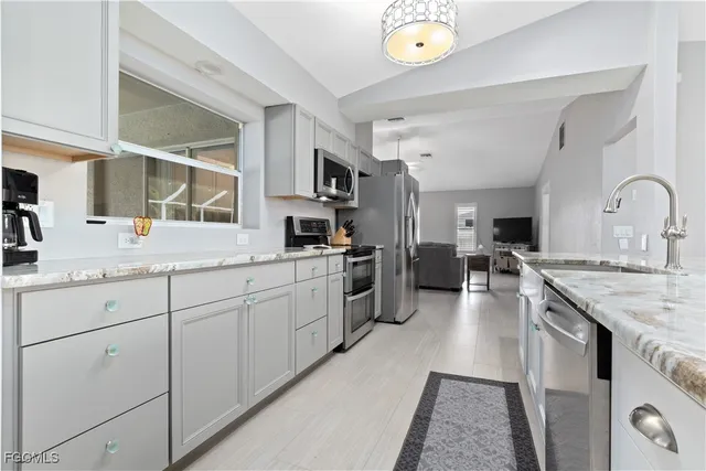 a kitchen with stainless steel appliances granite countertop lots of counter top space and cabinets