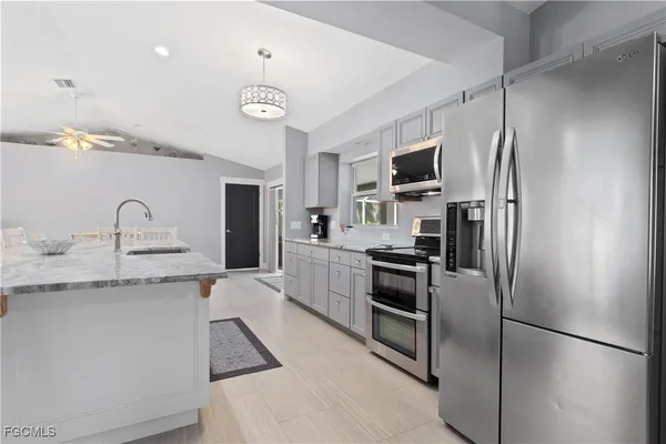 a kitchen with a refrigerator sink and stainless steel appliances