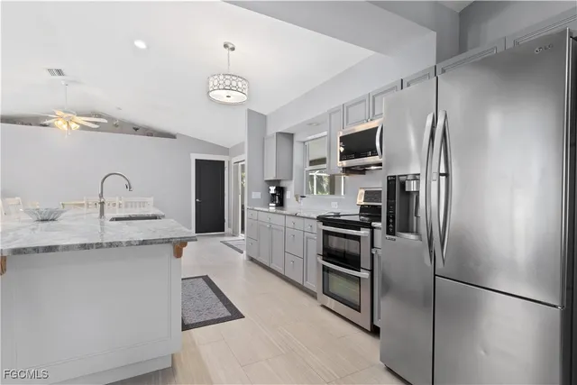 a kitchen with a refrigerator sink and stainless steel appliances