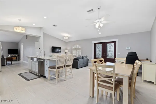 a view of a dining room with furniture and a chandelier