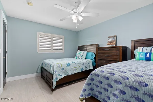 a bedroom with two beds and a dresser