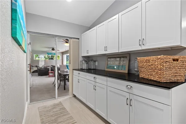 a kitchen with white cabinets