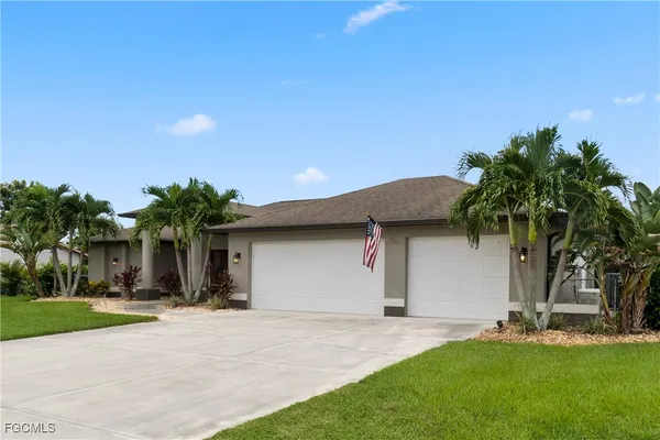 a front view of house with yard and palm tree