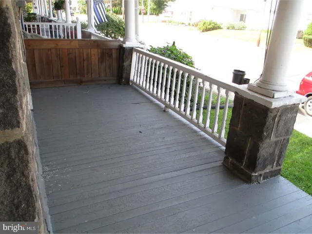 a view of a porch with wooden fence